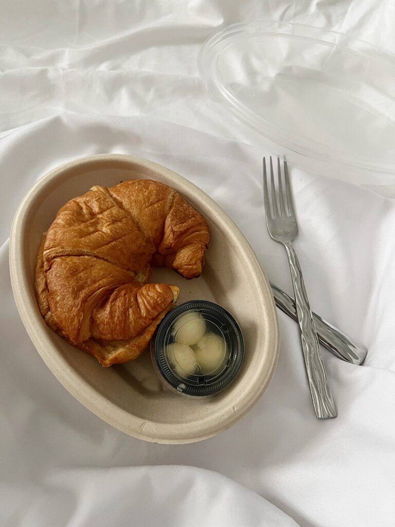 room service at the jupiter beach resort with a croissant side of butter in bed